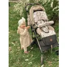 Makaszka stabilizáló párna és mintás babakocsi betét egy bézs színű babakocsiban egy mosolygó babával
