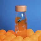 Petit Boum kék halas szenzoros palack narancssárga golyók között kék háttérrel