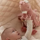 Újszülött baba a nagyméretű Little Dutch plüss flamingó mellett a játszószőnyegen